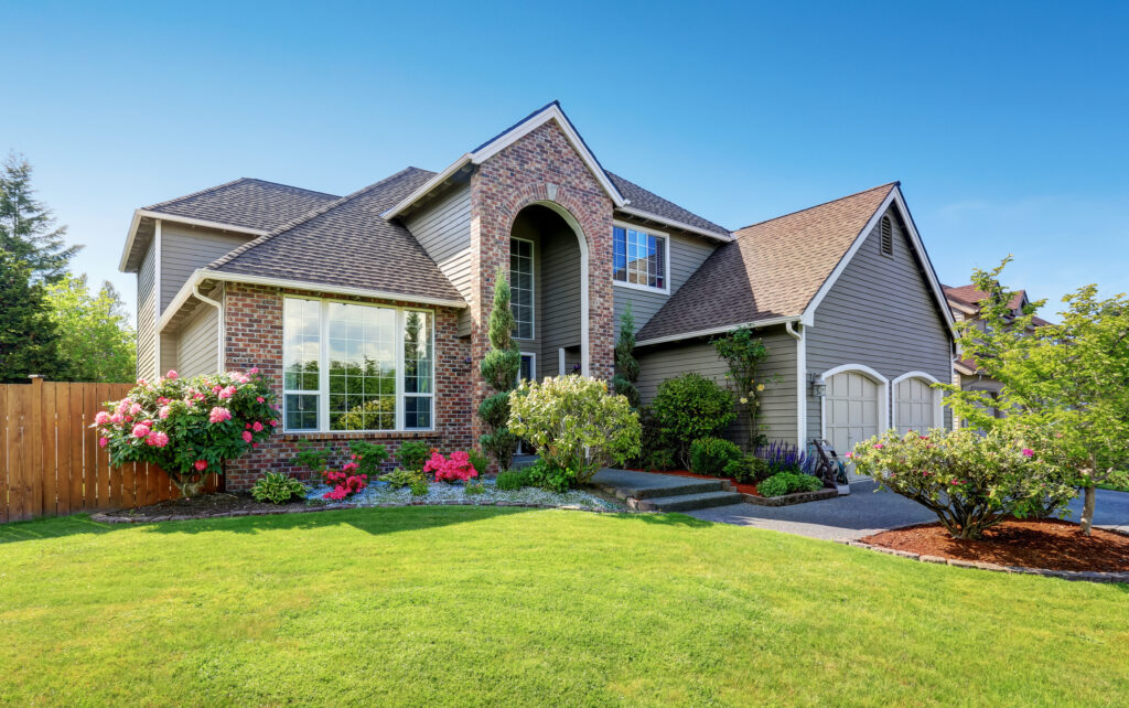 Luxury house exterior with brick and siding trim and double garage. Pest proofed home.